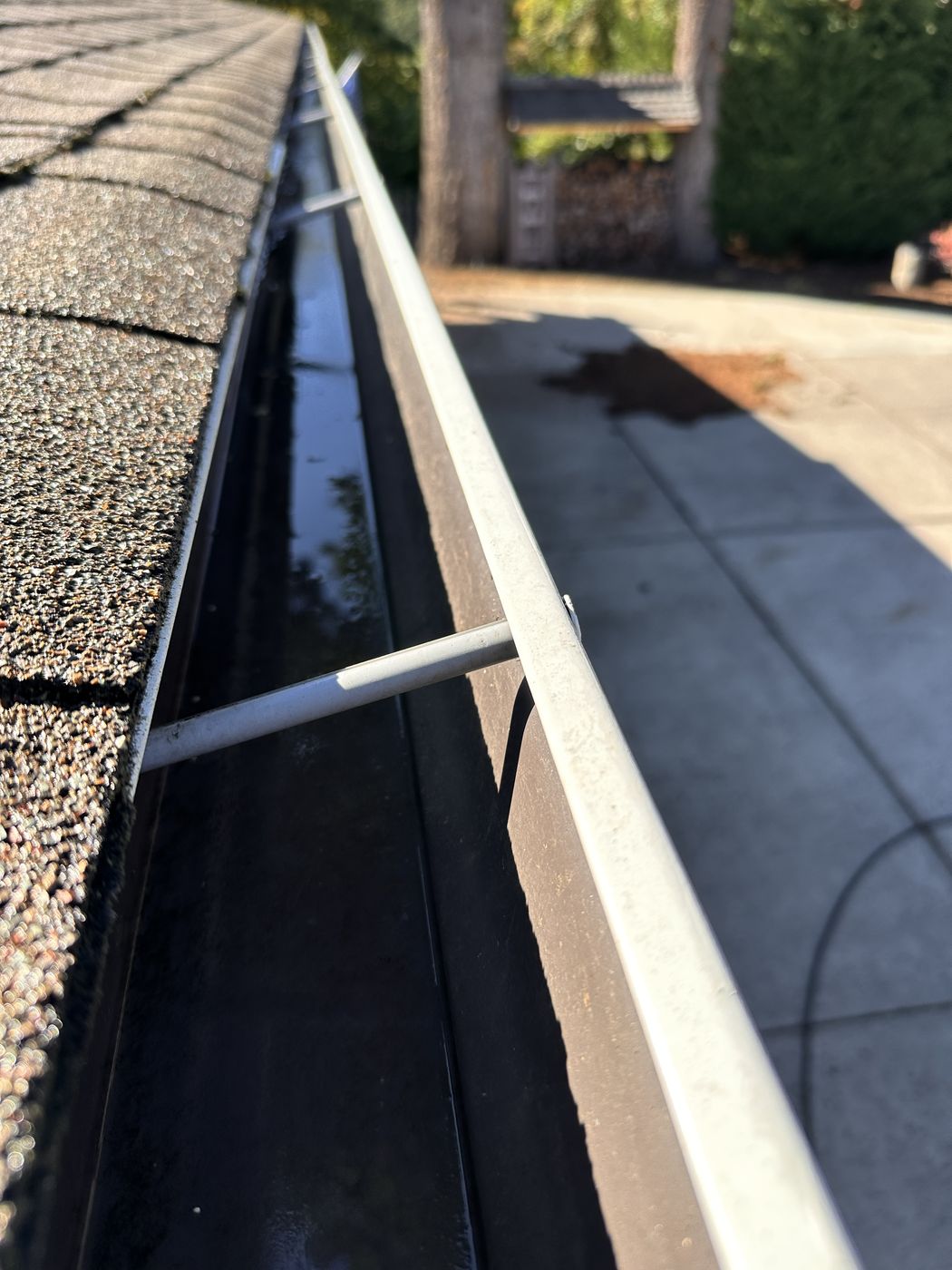 Same gutter after cleaning — completely clear and flowing